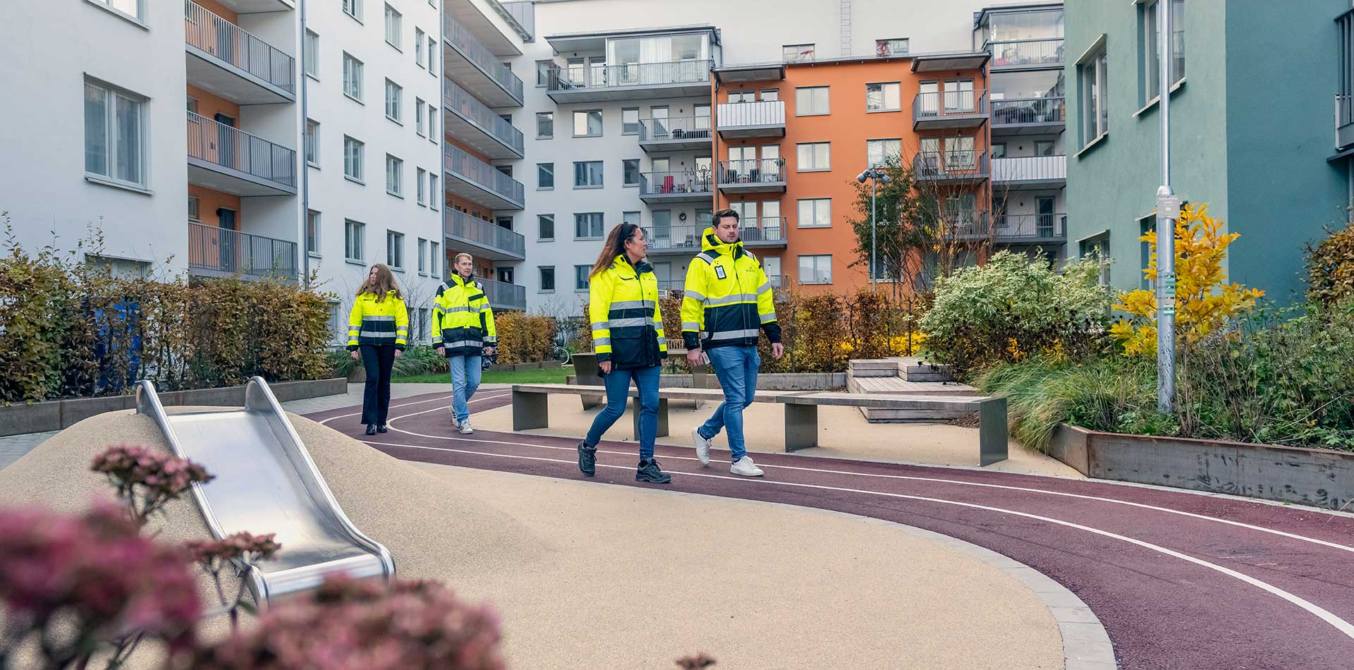Bonavan työntekijöitä kävelemässä uudella asuinalueella kerrostalojen pihapiirissä.