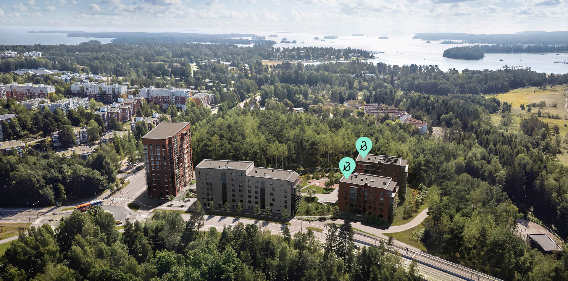 Ilmakuva Espoon Tiirasta, jossa Bonavan asuinkerrostalot sijaitsevat vehreän metsän reunalla lähellä merenrantaa.