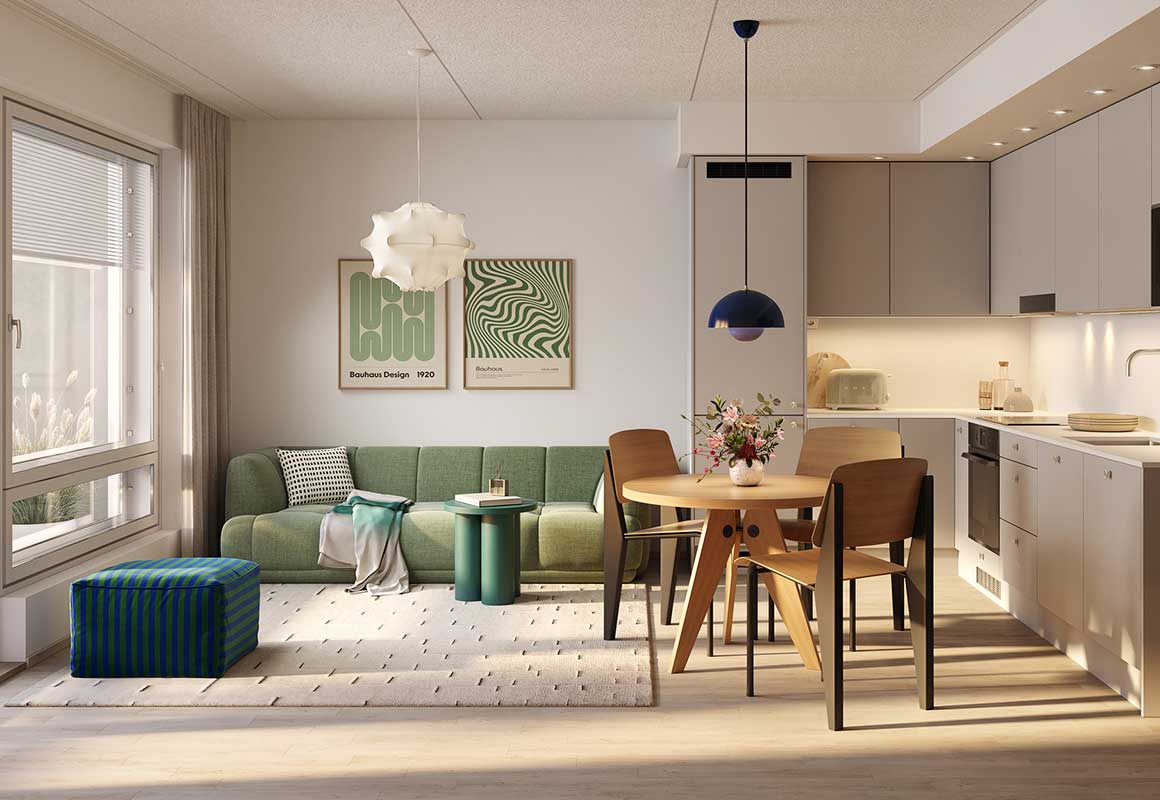 Tampereen Vienon valoisa olohuone ja avokeittiö, vihreä sohva, ruokailuryhmä ja vaaleasävyinen keittiö taustalla.