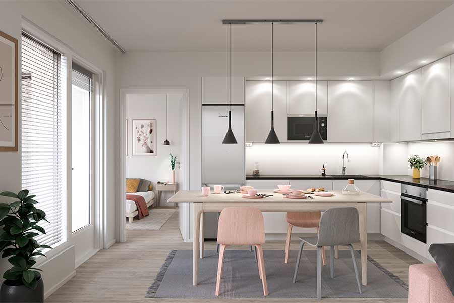 Vaalea keittiö, jossa on ruokapöytä neljällä tuolilla, kolme riippuvalaisinta ja näkymä makuuhuoneeseen.
