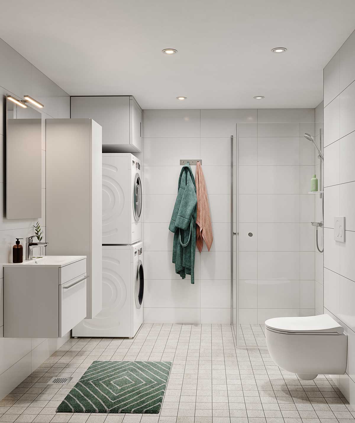 Moderni ja valoisa kylpyhuone, jossa kiiltävän valkoiset seinälaatat ja harmaat lattialaatat luovat raikkaan tunnelman. Tilassa on seinään kiinnitetty wc, lasiseinällä rajattu suihku sekä vaaleat kalusteet. Pesutorni sijoittuu siististi kaapiston viereen, ja kokonaisuutta täydentävät vihreät pyyhkeet ja kuviollinen matto.